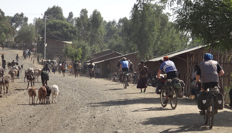 Marco (before), Willem (middle) and Marc (behind) arrive in a village