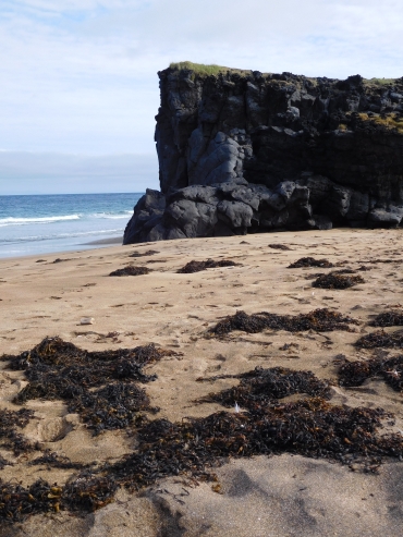 Basalt cliff on the beach of Skarđsvík